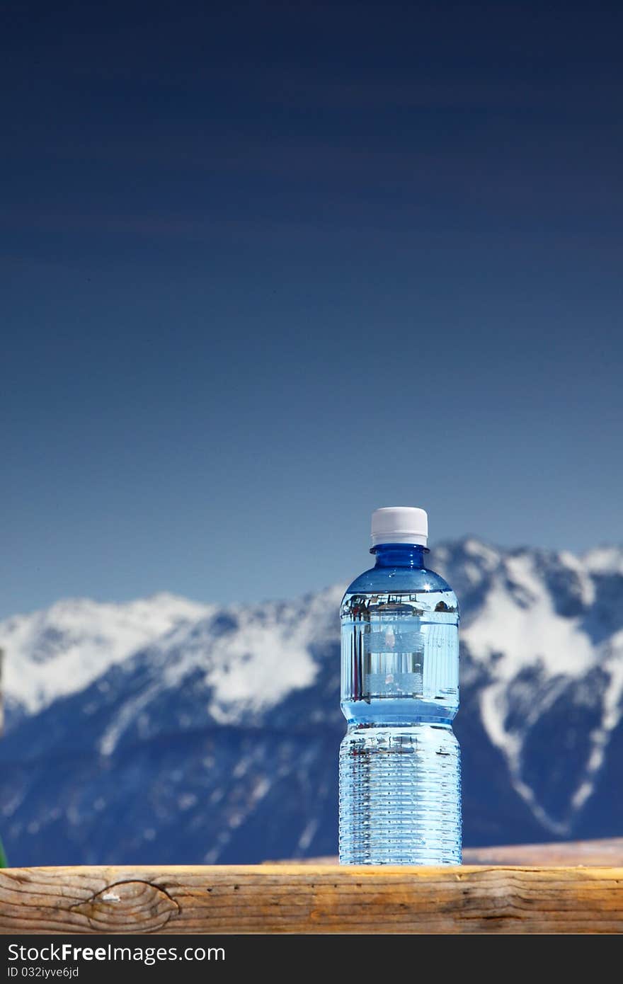 Water in cup mountains on background. Water in cup mountains on background