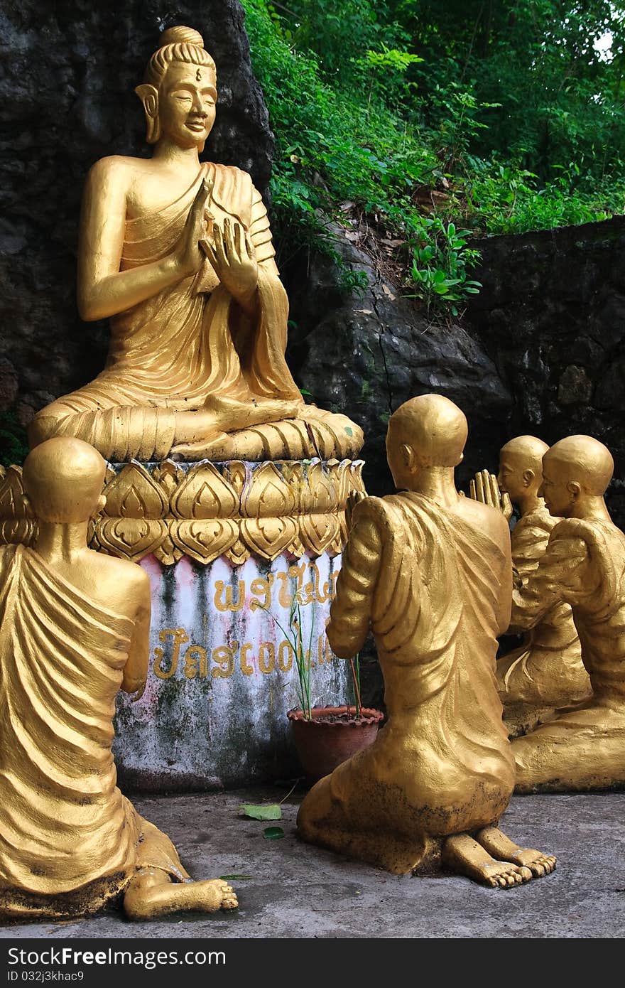 Gold sitting buddha surrounded by monk statues,Phou Si Hill, Luang Prabang, Laos, Asia. Gold sitting buddha surrounded by monk statues,Phou Si Hill, Luang Prabang, Laos, Asia