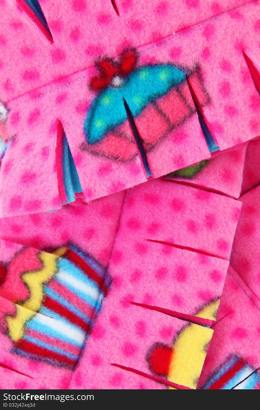 Close up of pink and multi colored cupcake themed scarf. Close up of pink and multi colored cupcake themed scarf.