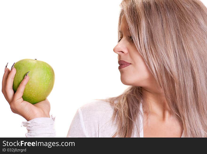 The lovely girl holds a green apple on a white background. The lovely girl holds a green apple on a white background