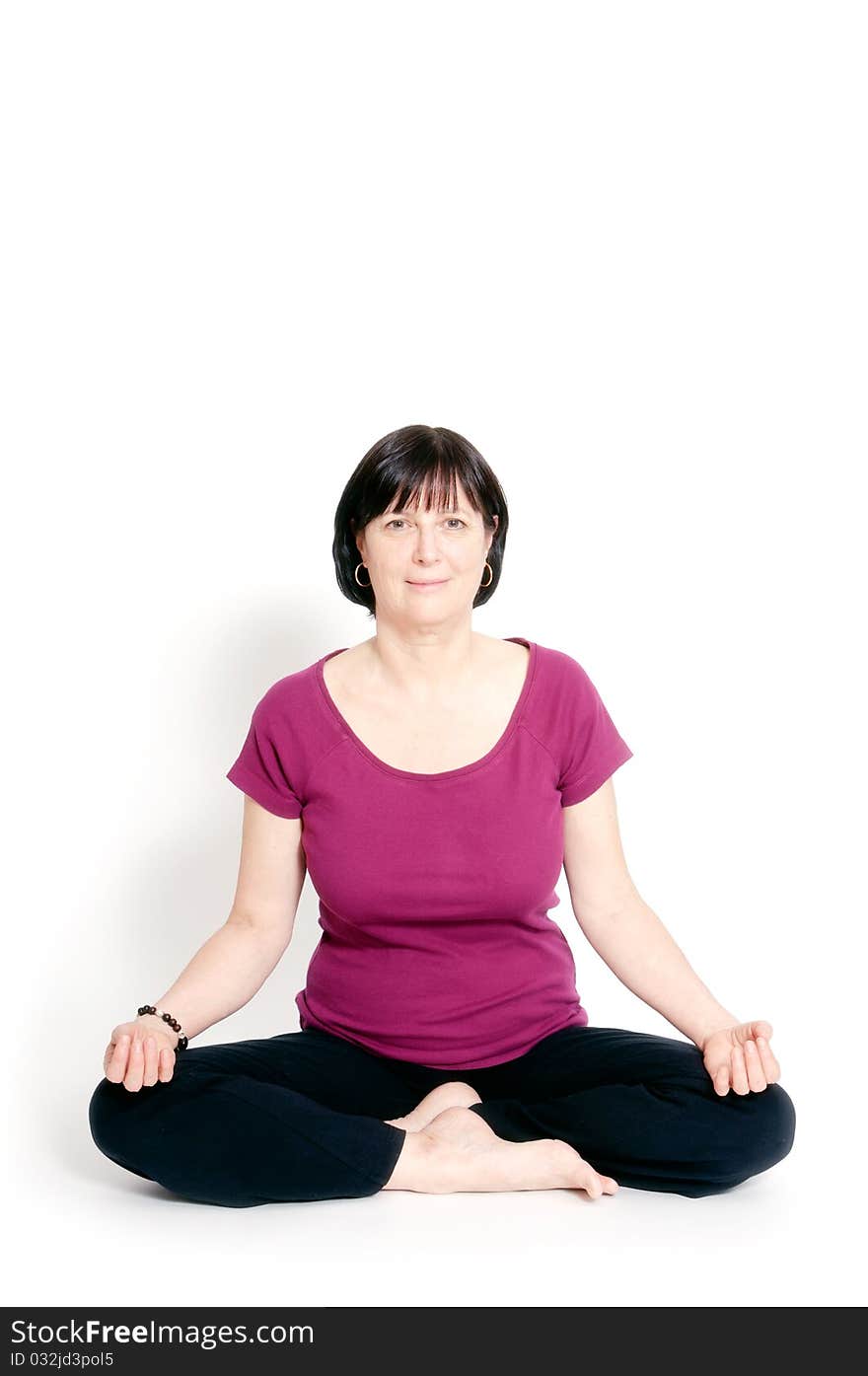 Aged woman sitting in lotus seat practicing yoga. Aged woman sitting in lotus seat practicing yoga.