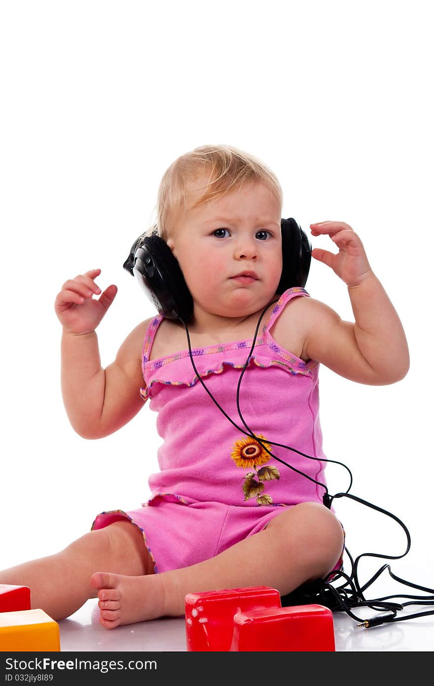 Baby with headphones, isolated on a white background