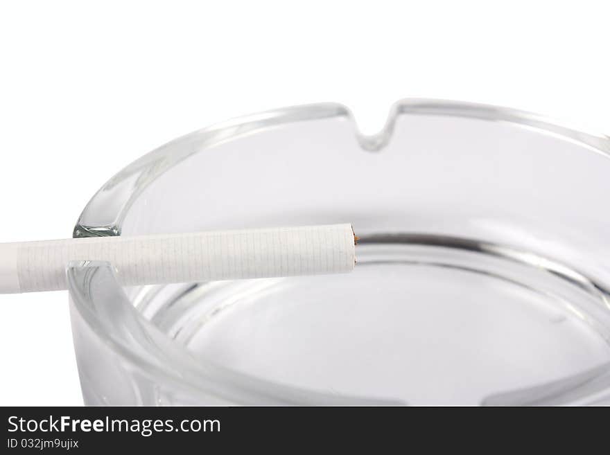 Ashtray with cigarette close-up isolated on white background. Ashtray with cigarette close-up isolated on white background