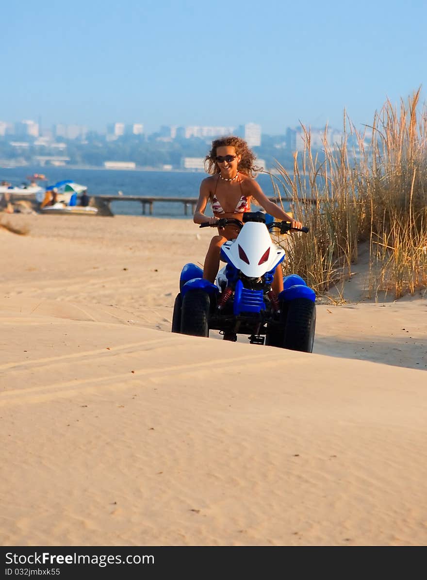 Woman on motobike on beach