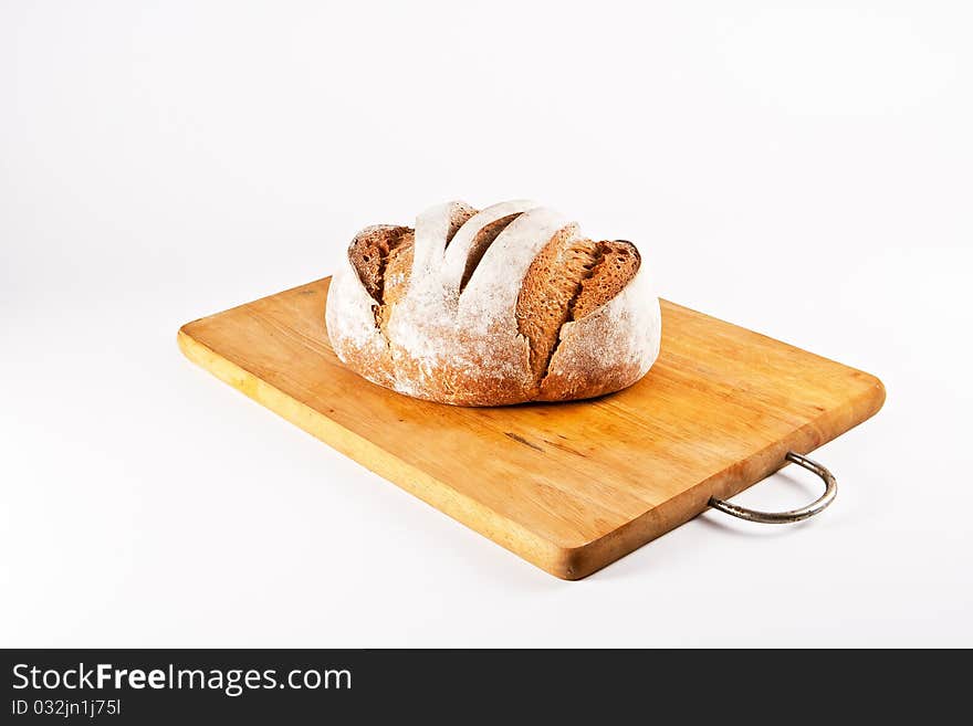 Homemade white bread lying on cutting board