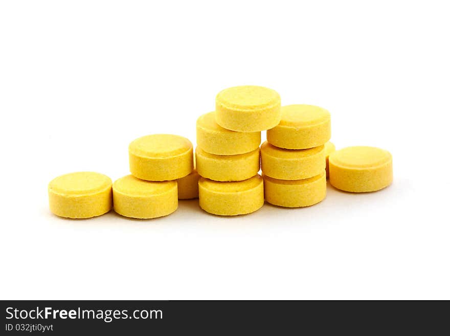 Yelow pills isolated on white