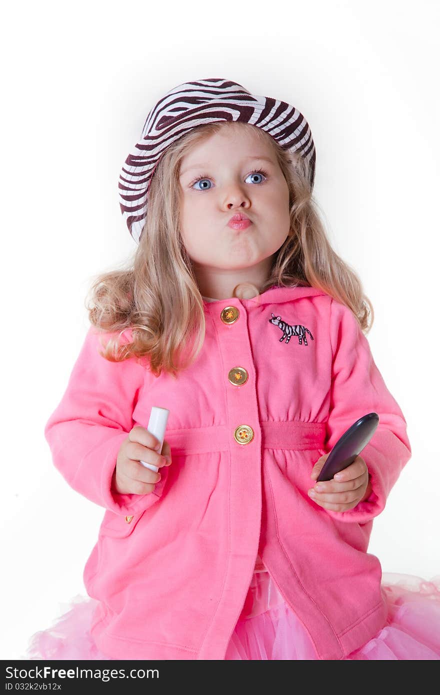 Fashionable little girl with lipstick and mirror sending a kiss. Fashionable little girl with lipstick and mirror sending a kiss