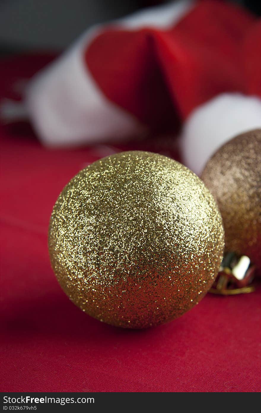 Christmas balls with Santa hat on red background. Christmas balls with Santa hat on red background