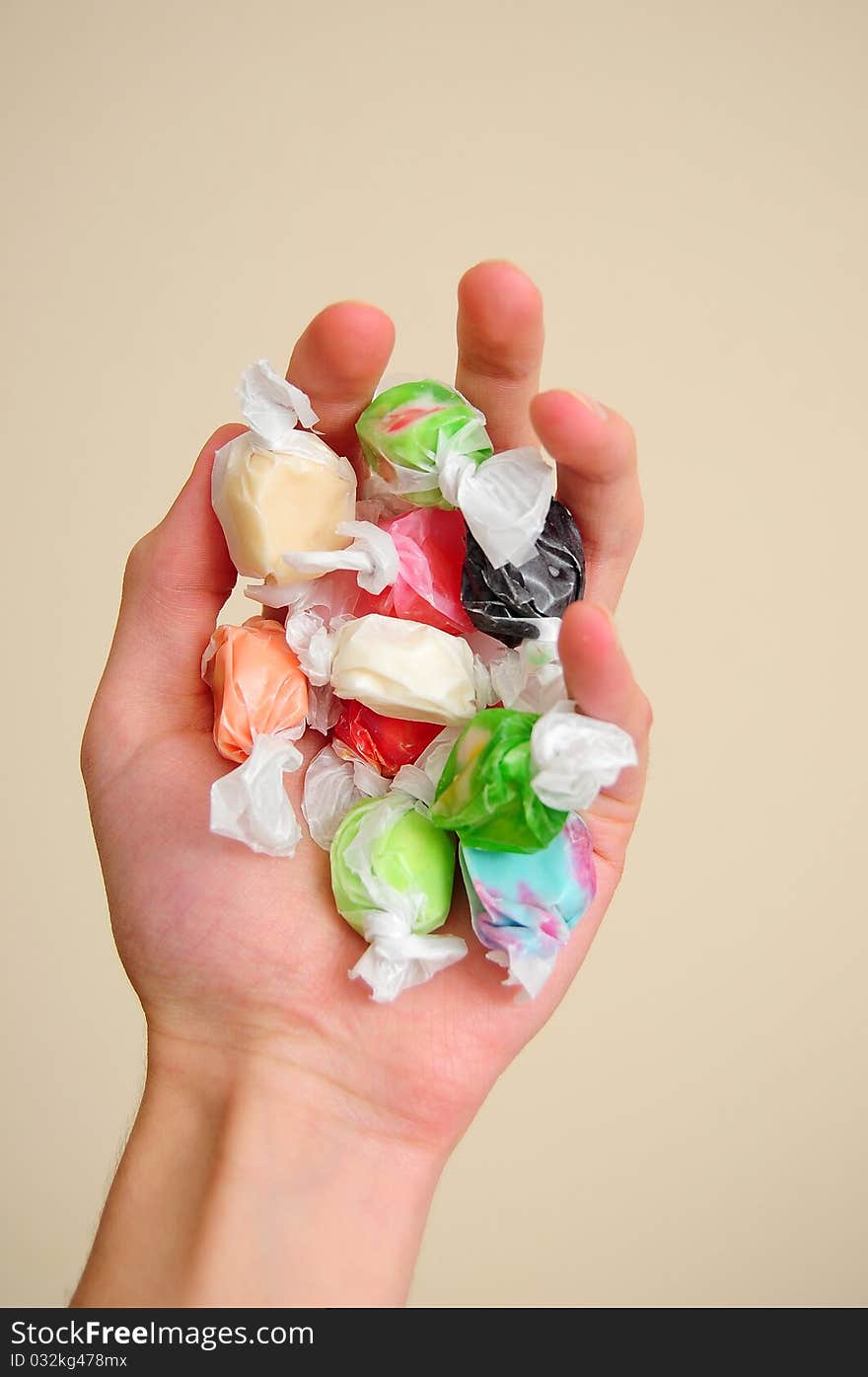 A pile of multicolored saltwater taffy candy on a white cloth.