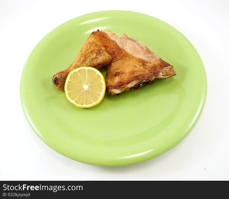 Chicken leg on green plate. Chicken leg on green plate