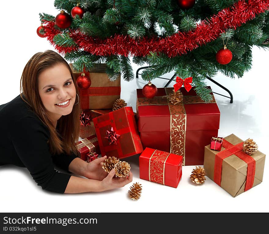 Young beautiful girl near the Christmas tree with lots of presents. Young beautiful girl near the Christmas tree with lots of presents