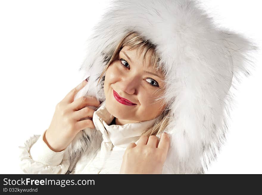 Portrait of the girl in a winter fluffy cap. Isolated on white