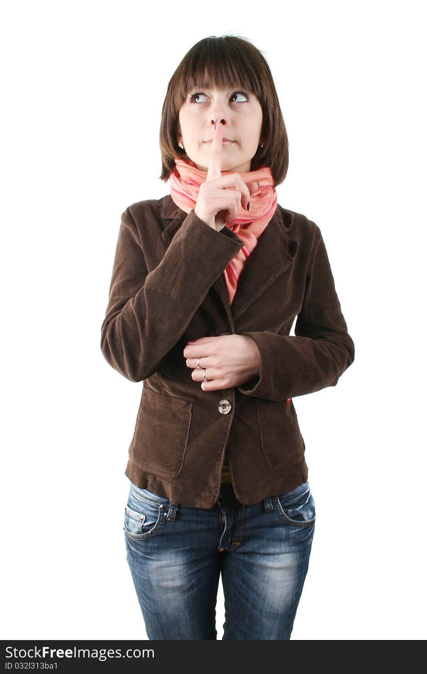 Shh. secret - Young girl in a brown coat with her finger over her mouth. Shh. secret - Young girl in a brown coat with her finger over her mouth