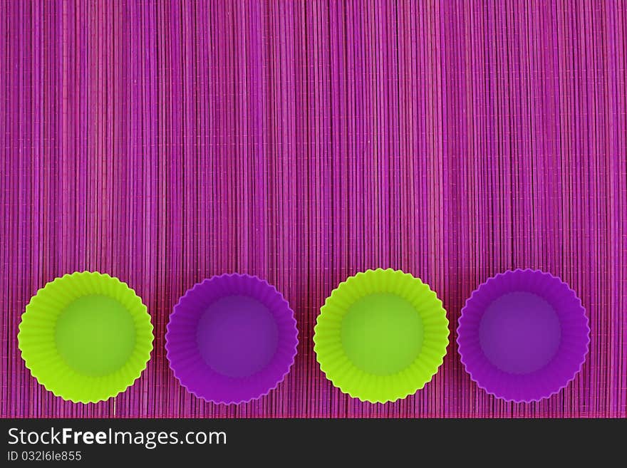 Colorful silicone baking cups on purple background