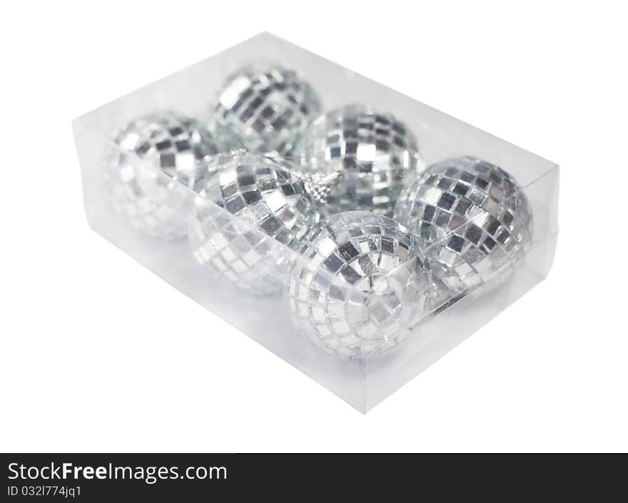 Box with Christmas ornaments in form of disco balls isolated on white background