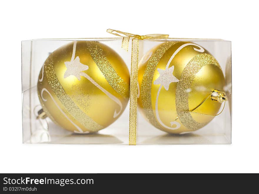 Two Christmas golden balls in transparent box isolated on white background