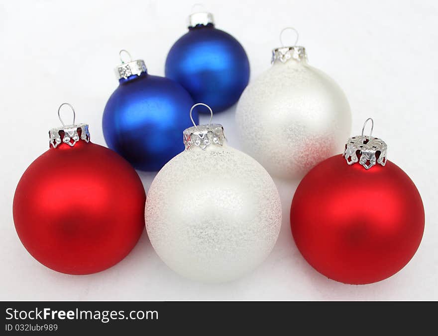 Christmas ball, blue red white lie in the snow. Christmas ball, blue red white lie in the snow