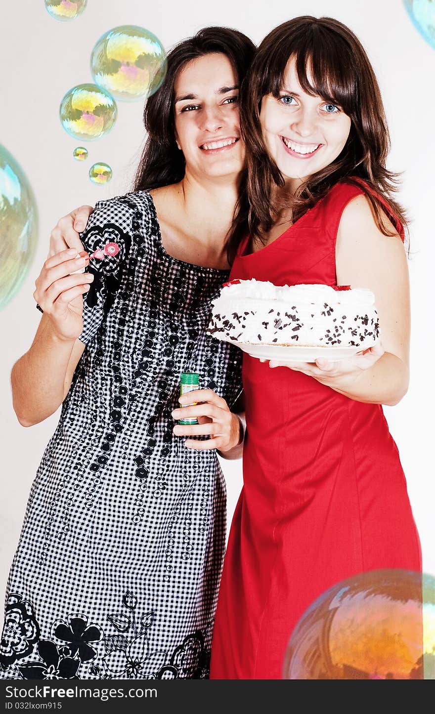 Happy beauty girls with soap balls and sweet cake