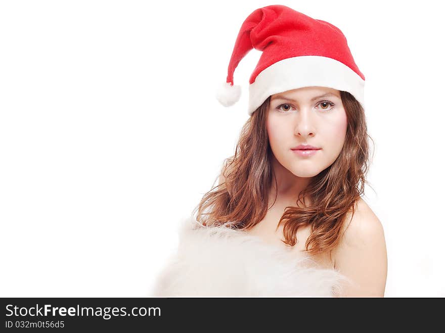 Portrait of a beautiful girl with a christmas hat isolated against a white background