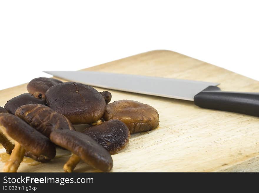 Mushrooms and knife on chopping board