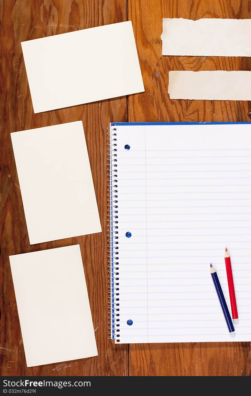 Notebook and Information clean sheets on the old wooden background.