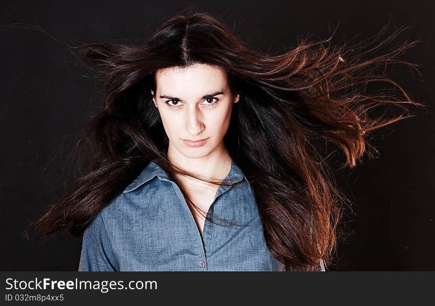 Beauty woman with brown hairs on the wind