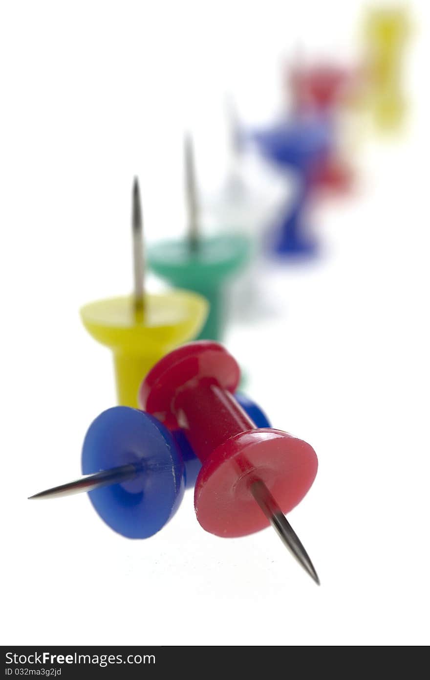 Multicolored pushpins isolated on a white