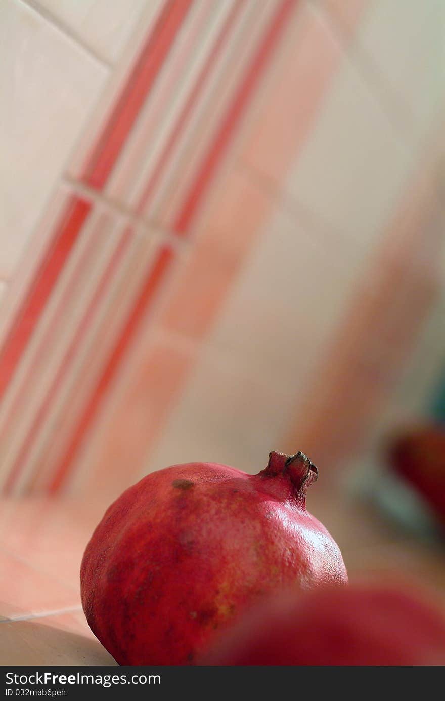 Fresh red pomegranate - pink red and white wall. Fresh red pomegranate - pink red and white wall