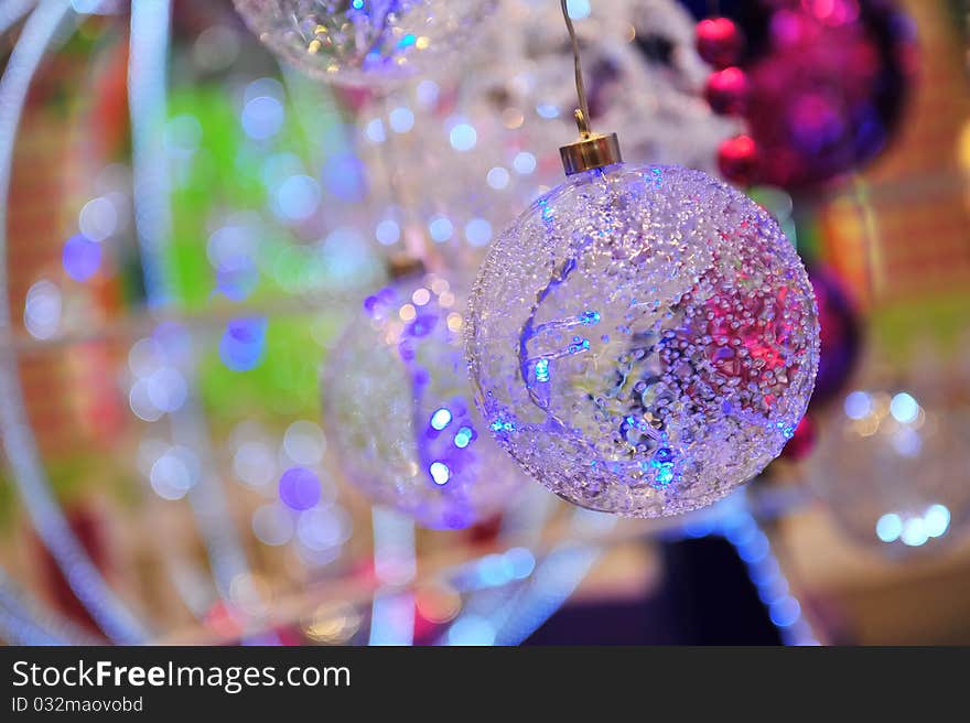 Glass Christmas balls with colourful bokeh background