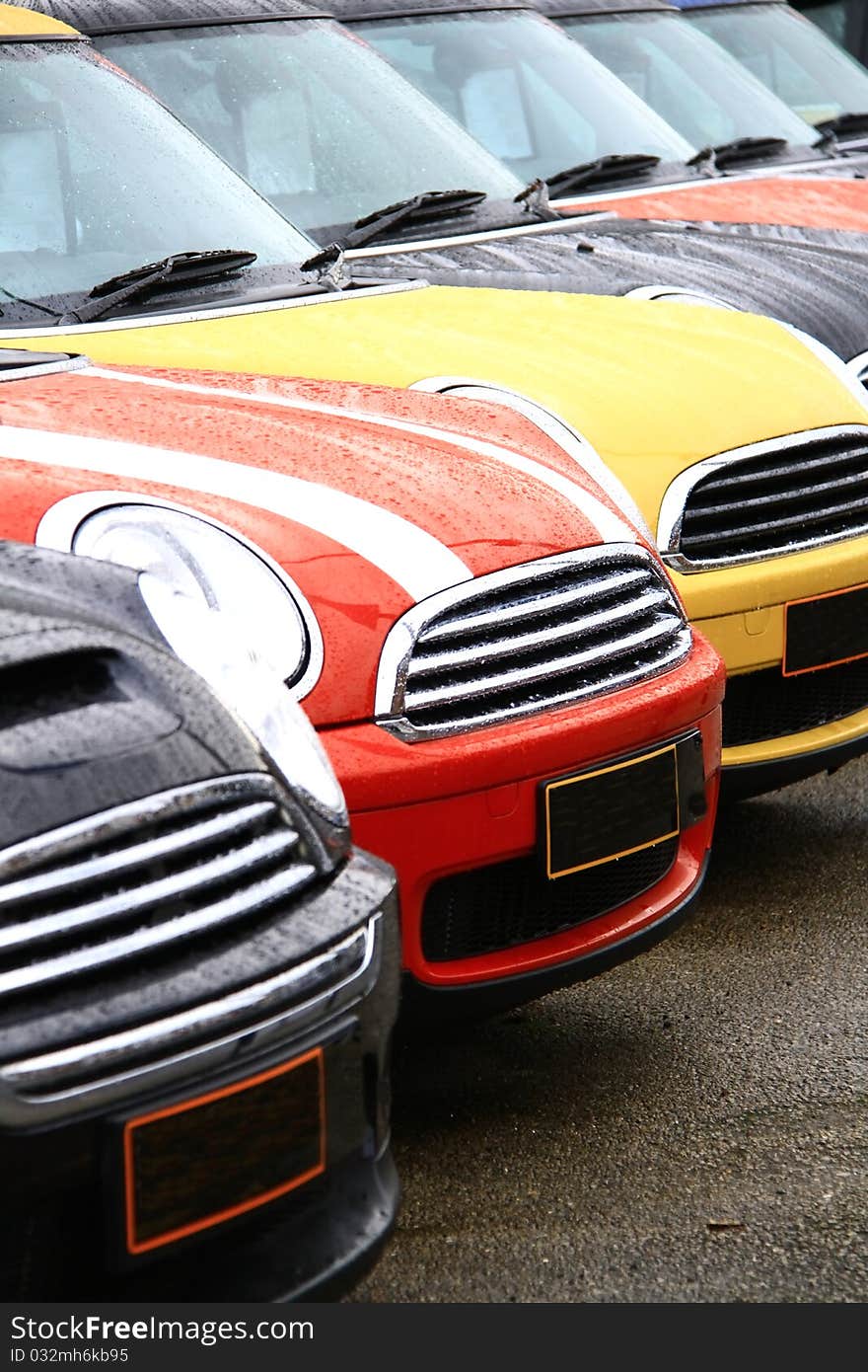 Cars lined up polished and clean on a wet day. Cars lined up polished and clean on a wet day