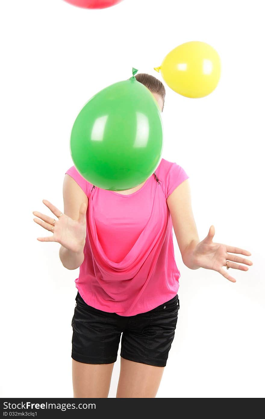 Young girl playing with balloons over white