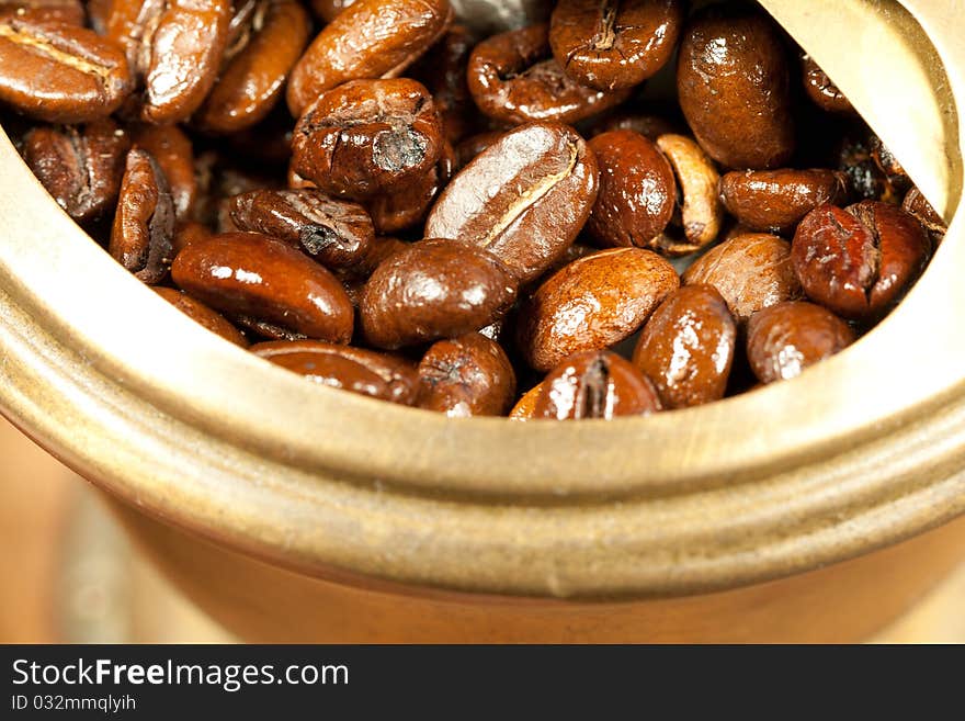 Fragrant fried coffee beans in the old coffee grinder. Fragrant fried coffee beans in the old coffee grinder