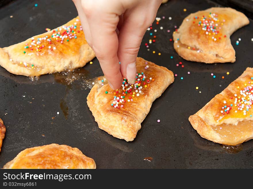 Girl decorates ready pies