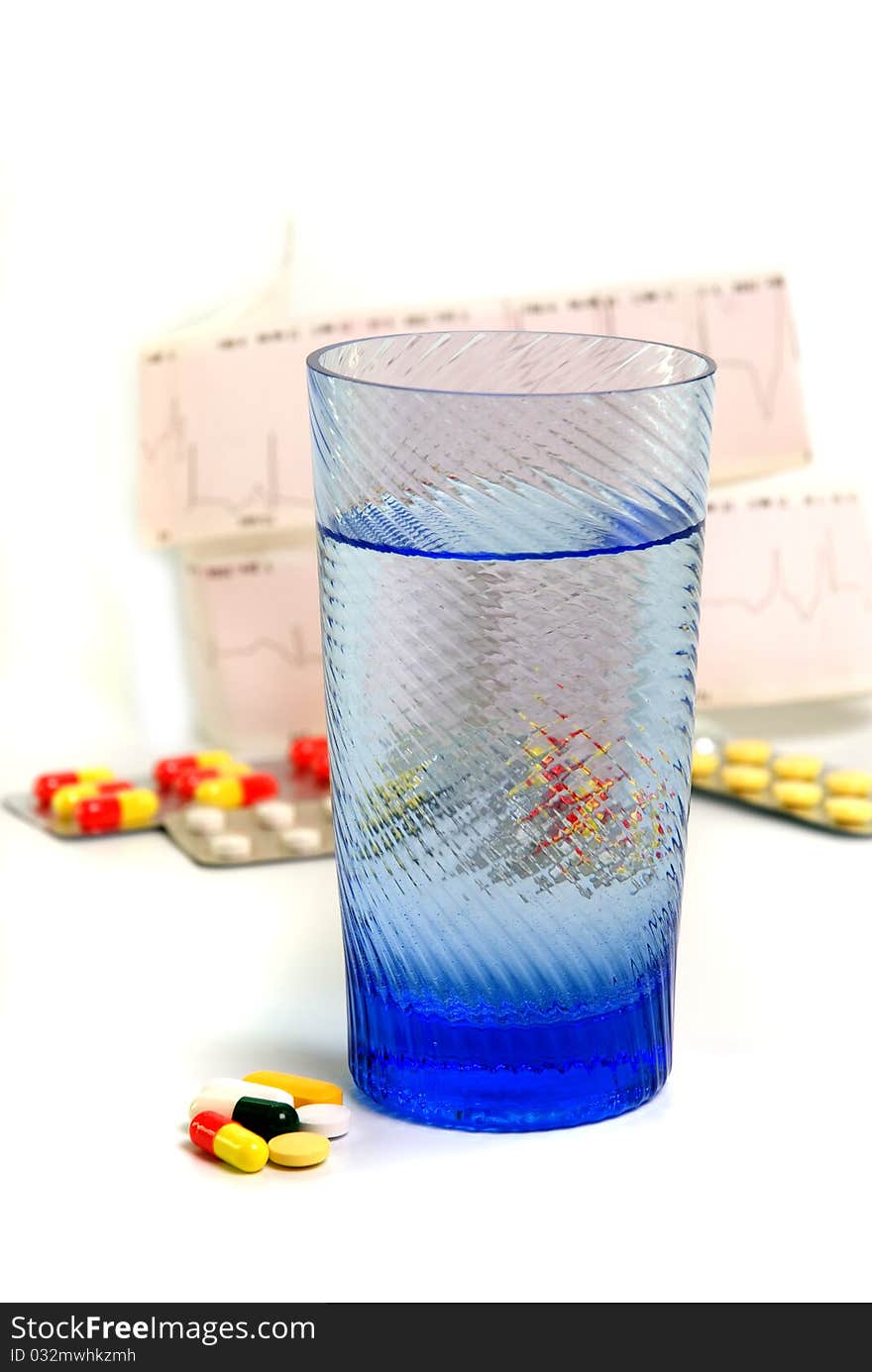 Different capsules with glass on white background