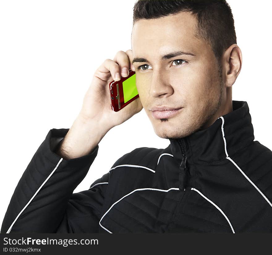 Studio shot of the young man in futuristic jacket with cell phone in right hand. Isolated on white background. Studio shot of the young man in futuristic jacket with cell phone in right hand. Isolated on white background