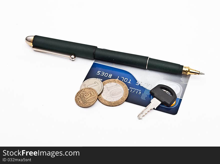 Handle, key, plastic card and coins on white background close-up. Handle, key, plastic card and coins on white background close-up