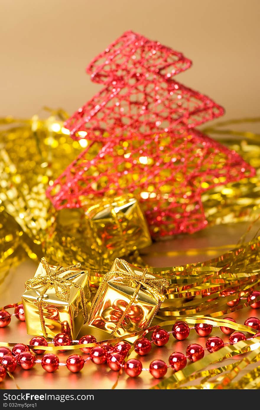 Christmas still life with golden gift boxes and red new year's tree