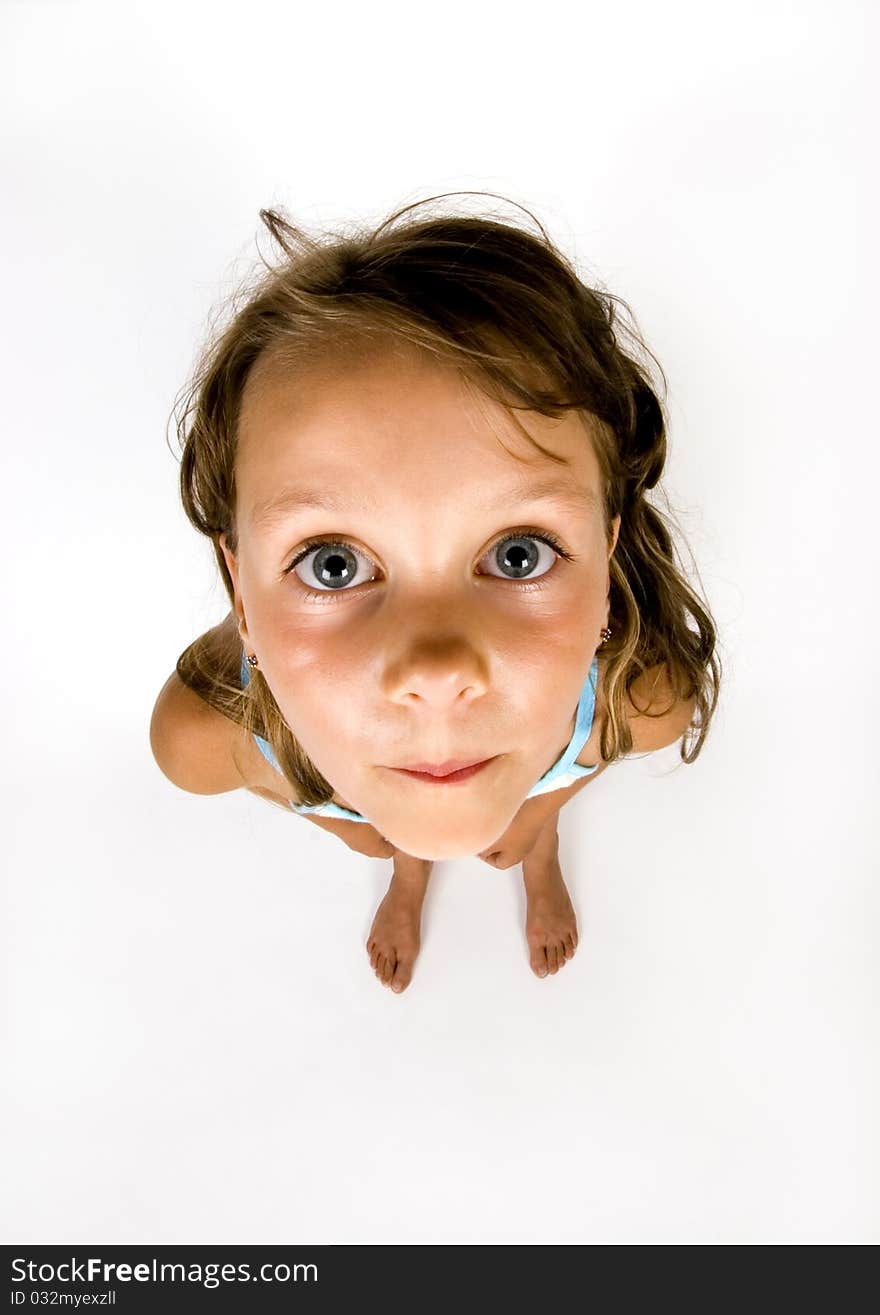 A sweet young girl. The child is on a white background. A sweet young girl. The child is on a white background