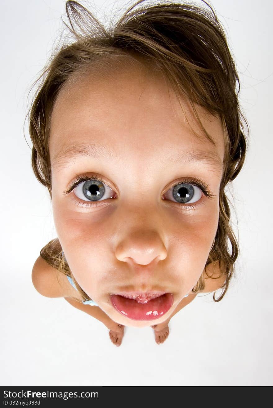 A sweet young girl. The child is on a white background. A sweet young girl. The child is on a white background