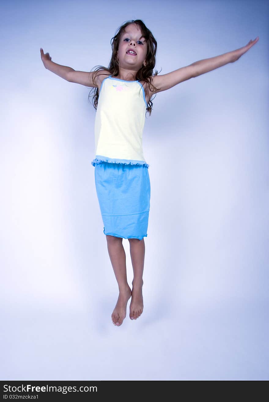 A sweet young girl. The child is on a white background. A sweet young girl. The child is on a white background