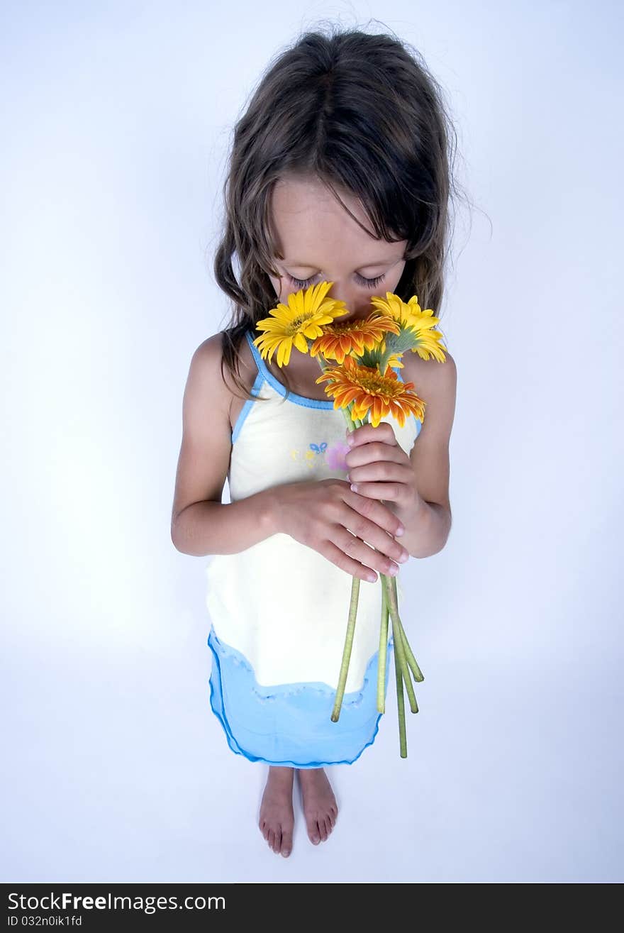 A little girl holding in her hand a beautiful flower. A little girl holding in her hand a beautiful flower