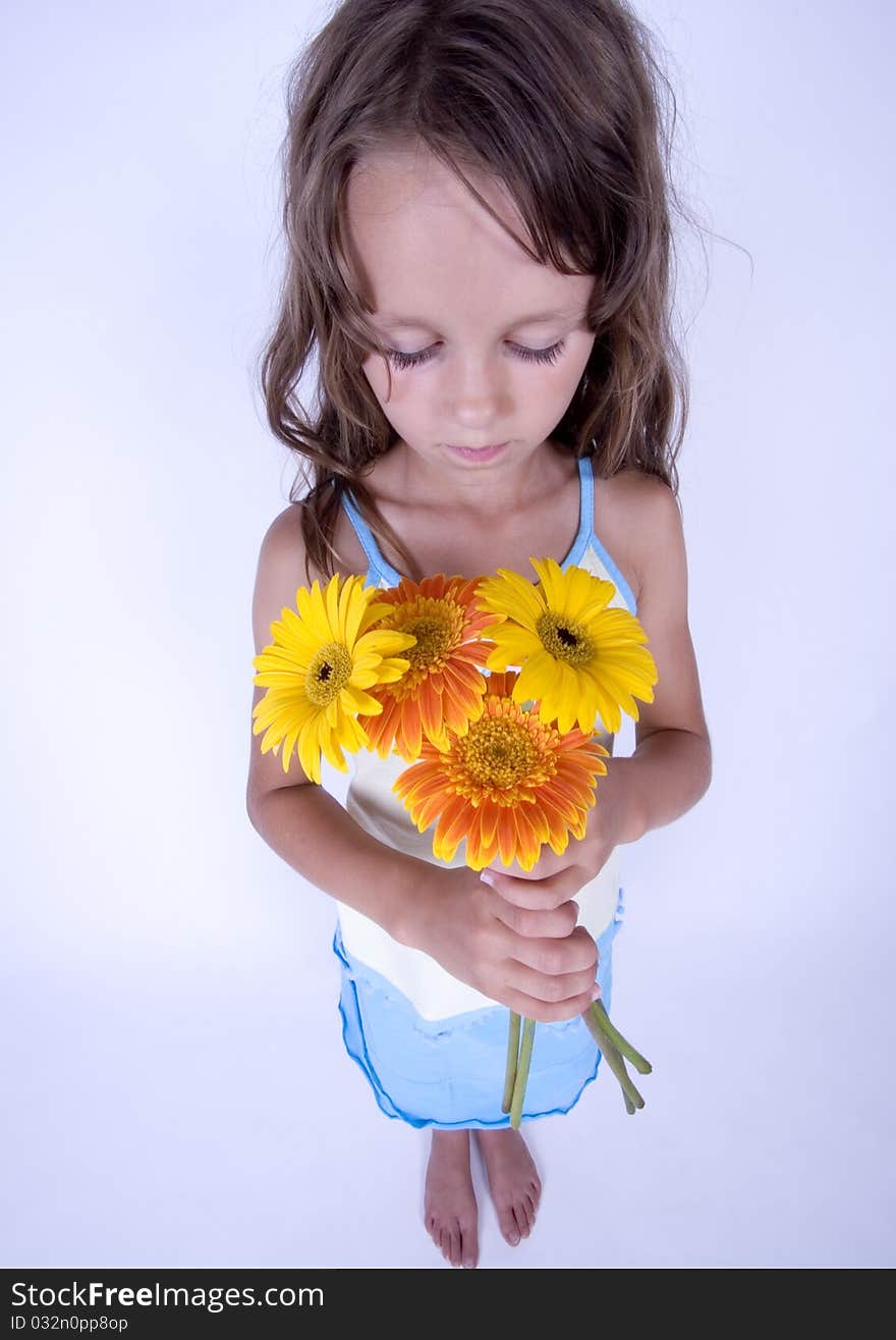 A little girl holding in her hand a beautiful flower. A little girl holding in her hand a beautiful flower