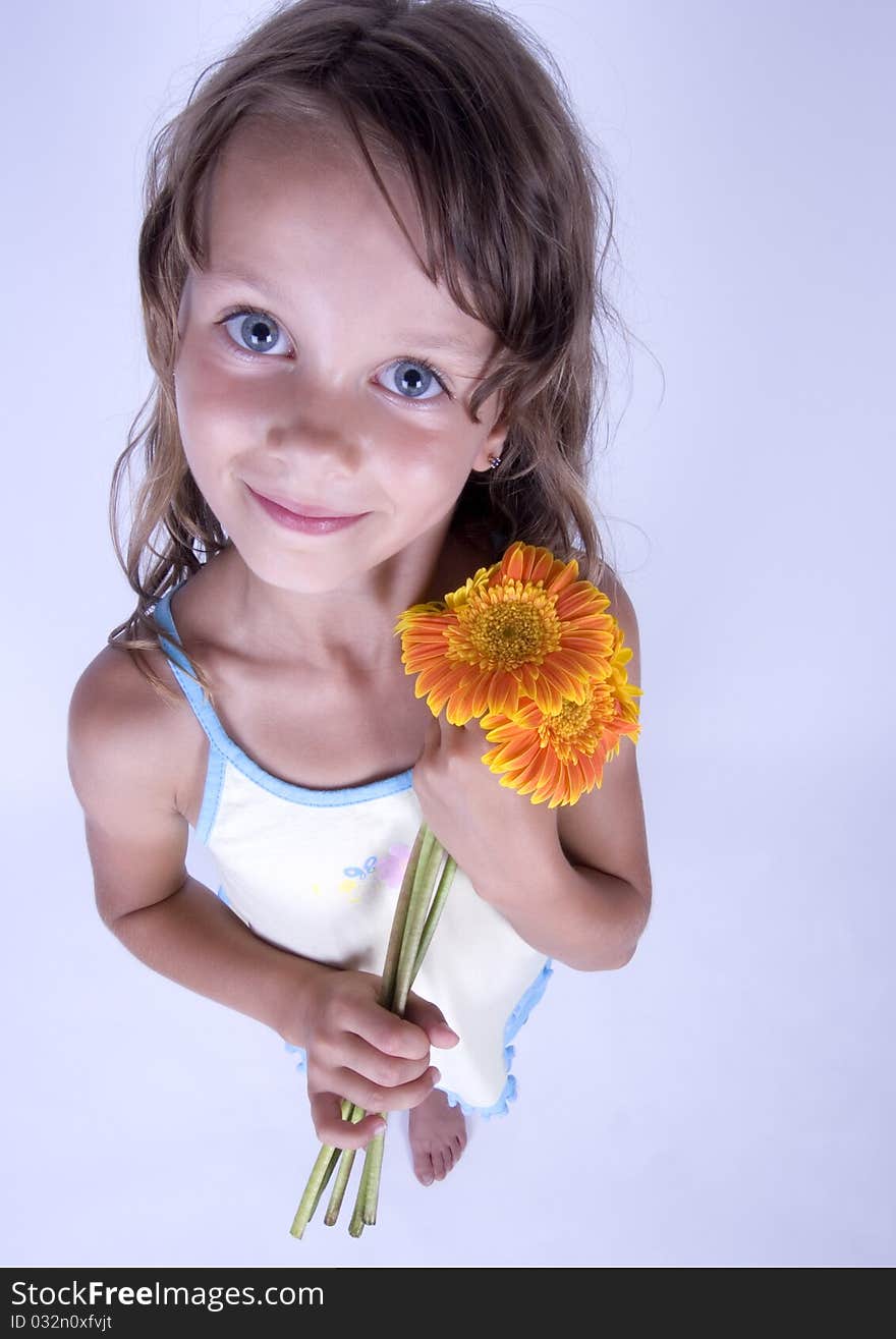 A little girl holding in her hand a beautiful flower. A little girl holding in her hand a beautiful flower