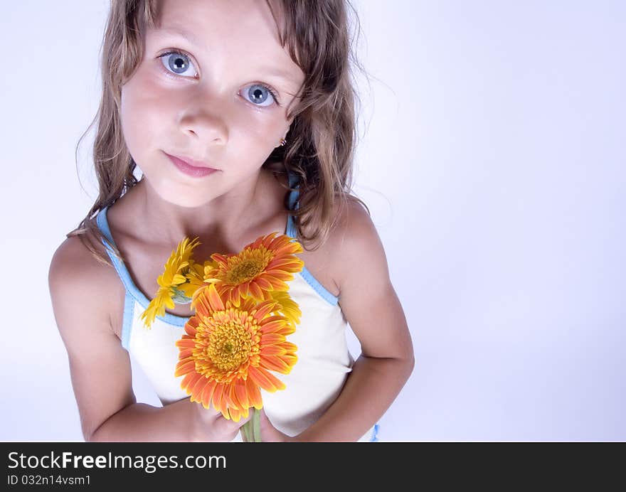 A little girl holding in her hand a beautiful flower. A little girl holding in her hand a beautiful flower