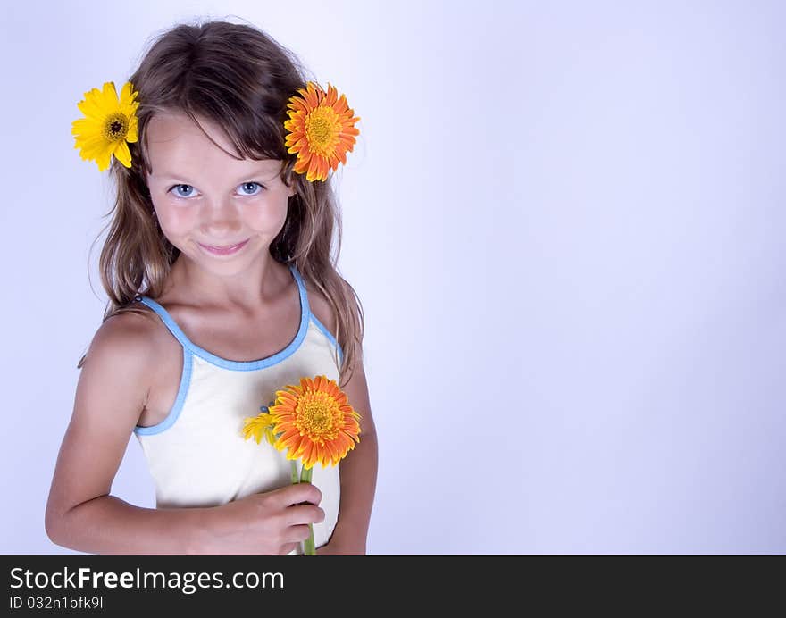 A little girl holding in her hand a beautiful flower. A little girl holding in her hand a beautiful flower