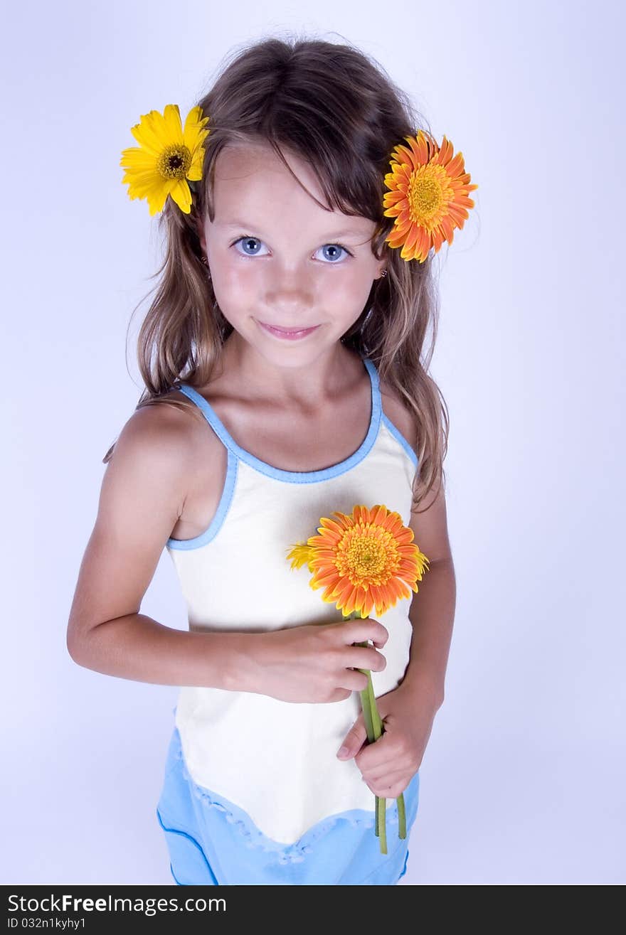 A little girl holding in her hand a beautiful flower. A little girl holding in her hand a beautiful flower