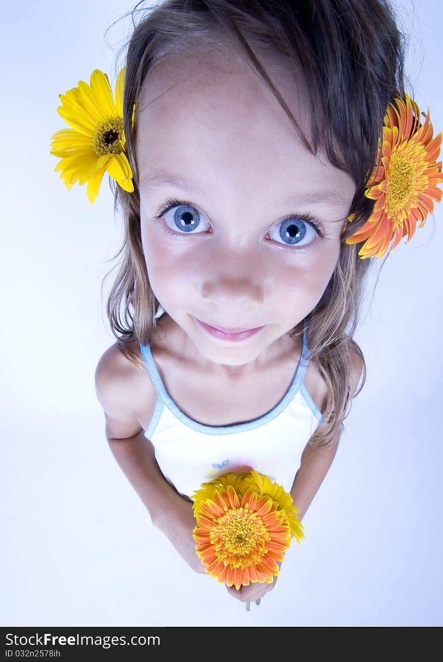 A little girl holding in her hand a beautiful flower. A little girl holding in her hand a beautiful flower