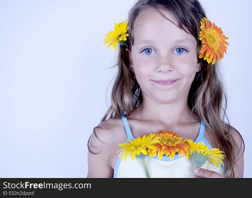 A little girl holding in her hand a beautiful flower. A little girl holding in her hand a beautiful flower