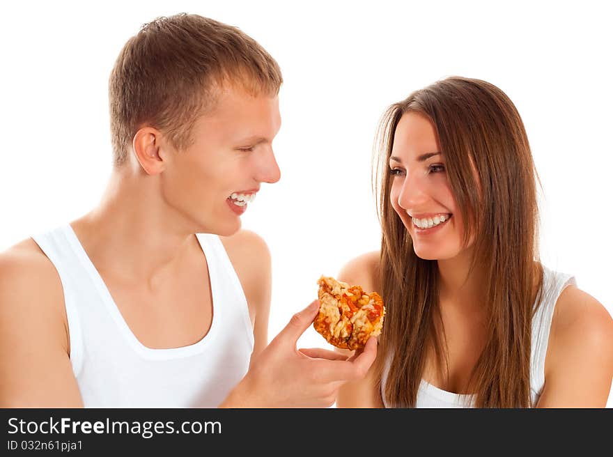 Beautiful couple eating pizza isolated over white