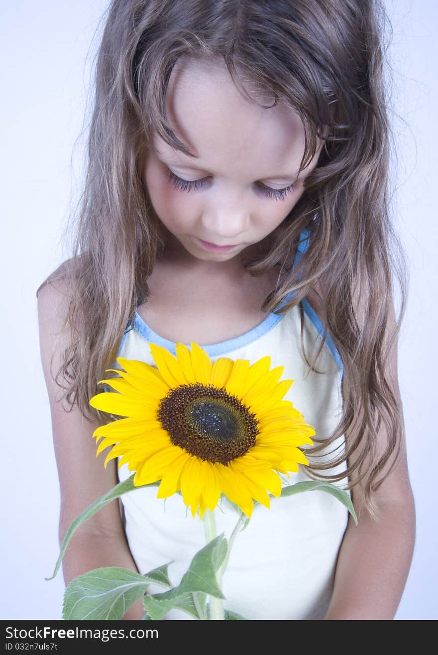 A little girl holding in her hand a beautiful flower